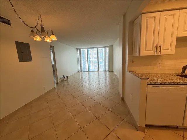 a view of a kitchen with a sink and a refrigerator