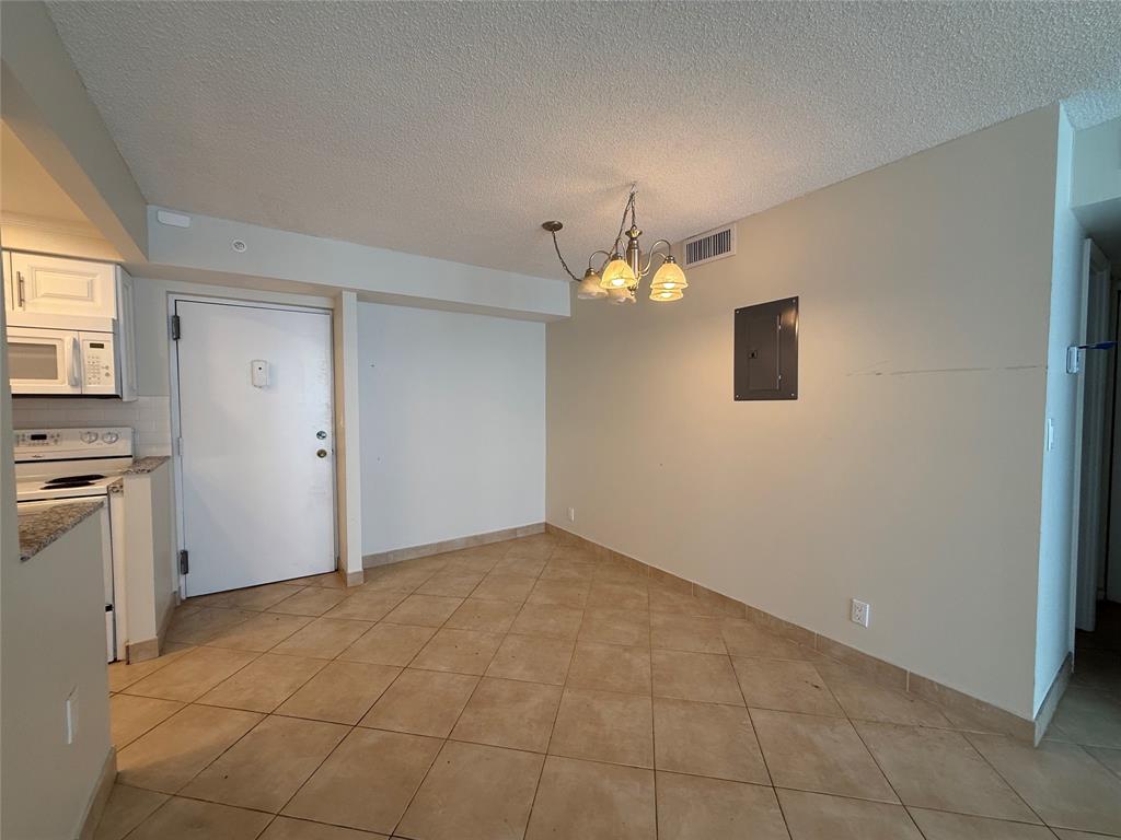 111 Briny Avenue, Unit 1805 Pompano Beach, FL 33062 - Photo 7 of 29 a view of an empty room with a window