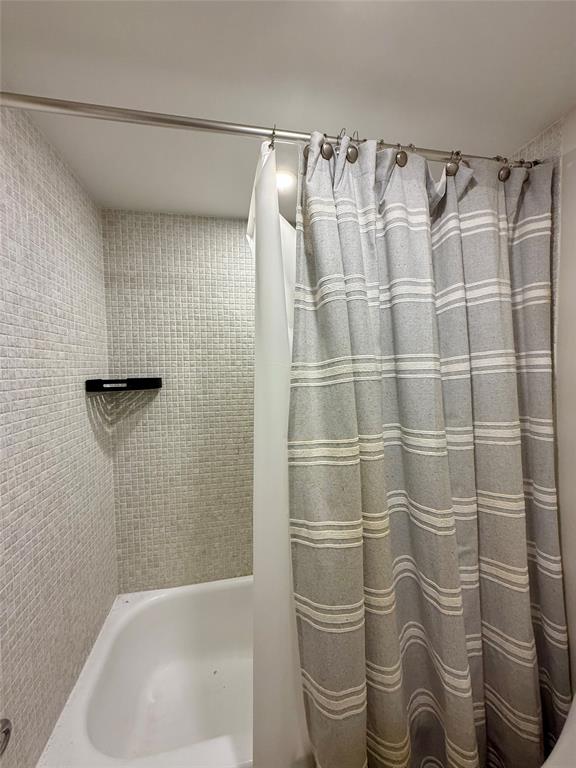 111 Briny Avenue, Unit 1805 Pompano Beach, FL 33062 - Photo 10 of 29 a bathroom with a shower curtain and a sink