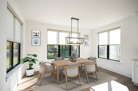 a dining room with furniture a chandelier and window