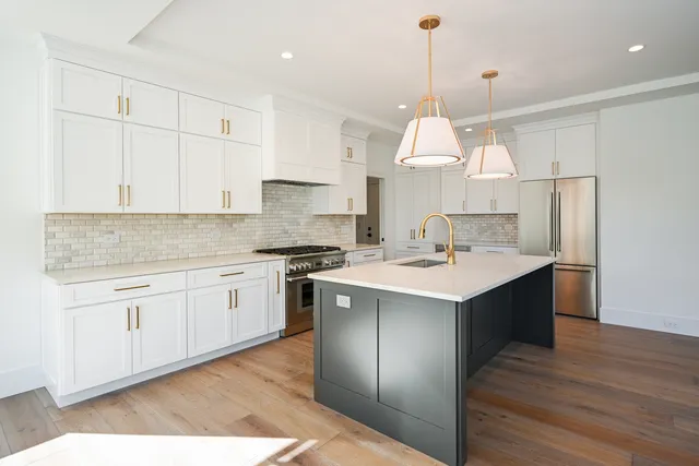 a kitchen with a sink cabinets and wooden floor