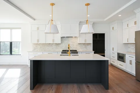 a kitchen with stainless steel appliances a sink stove and refrigerator