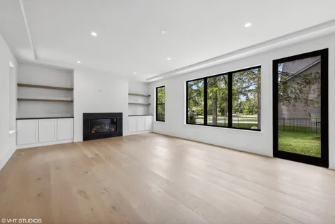 a view of an empty room with a fireplace and a window