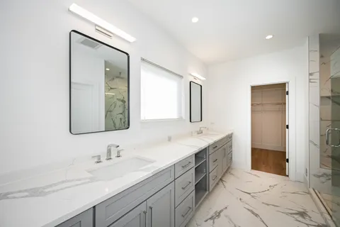 a bathroom with a granite countertop sink mirror and double