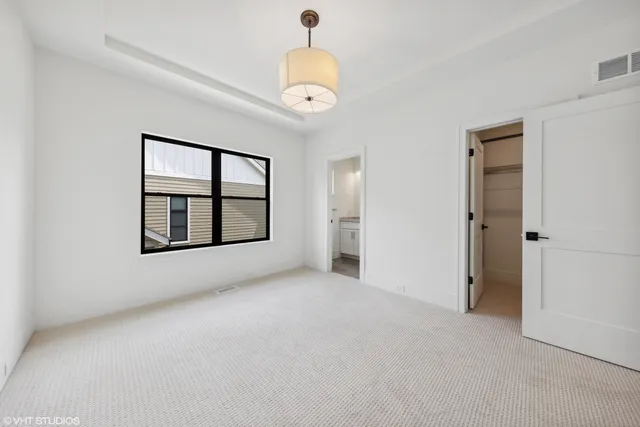 a view of a hallway with wooden floor and entryway
