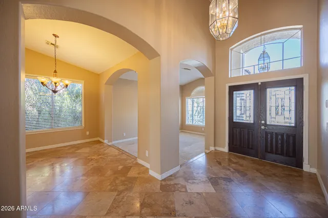 a view of an entryway with wooden floor and a livingroom