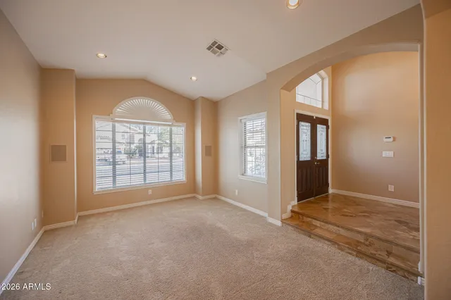 an empty room with windows and closet