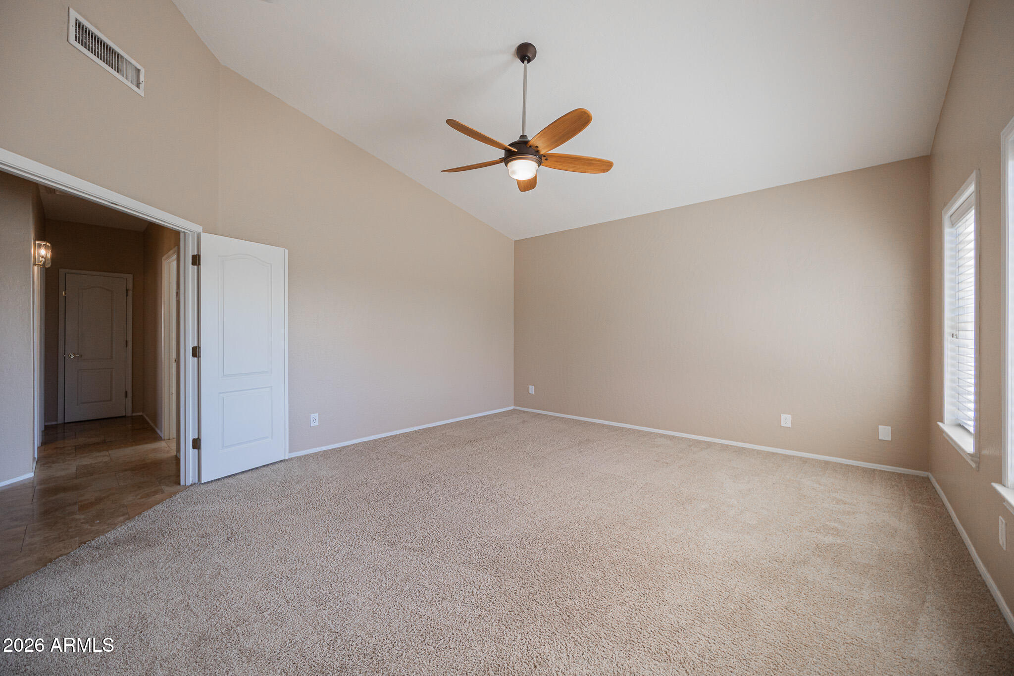 1767 West Redfield Road Gilbert, AZ 85233 - Photo 17 of 40 an empty room with a ceiling fan and window