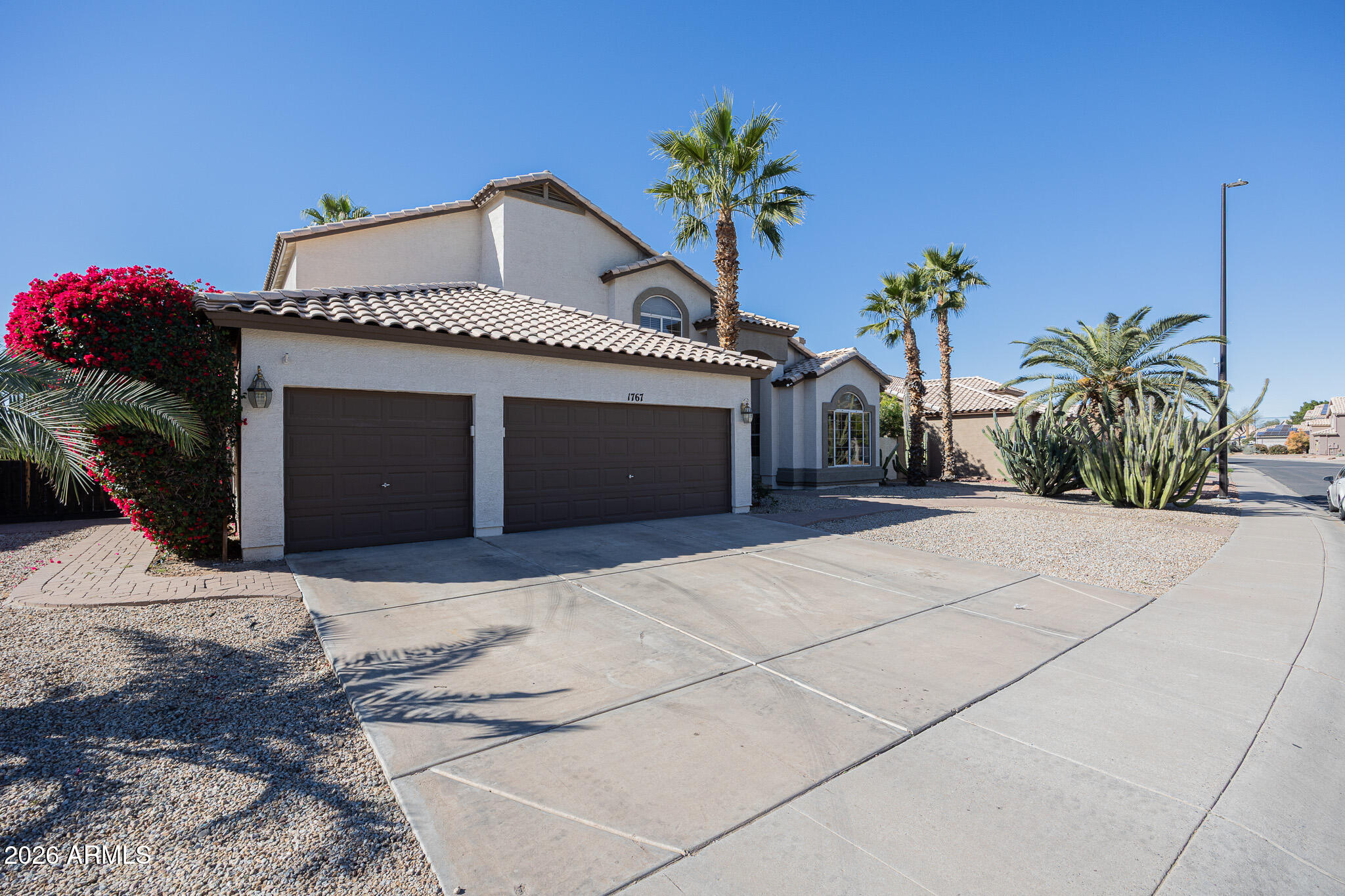 1767 West Redfield Road Gilbert, AZ 85233 - Photo 2 of 40 a front view of a house with a yard and garage
