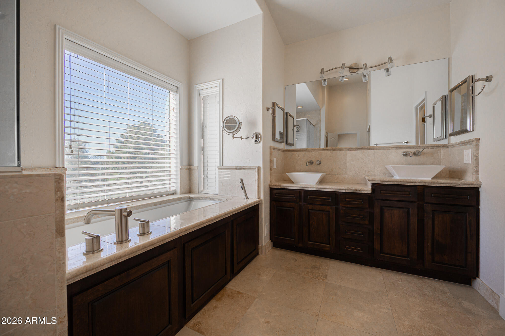 1767 West Redfield Road Gilbert, AZ 85233 - Photo 21 of 40 a kitchen with a sink and wooden cabinets