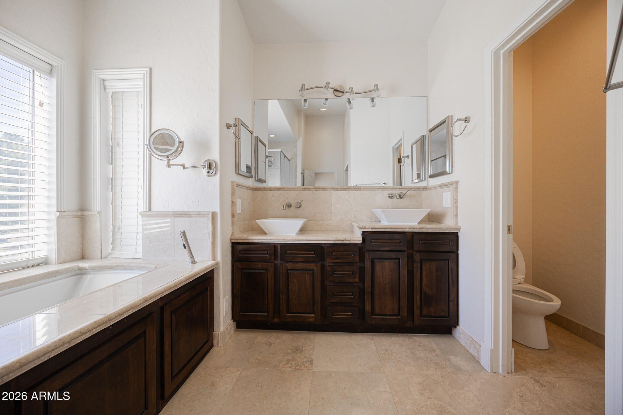 1767 West Redfield Road Gilbert, AZ 85233 - Photo 22 of 40 a spacious bathroom with a granite countertop sink and a mirror