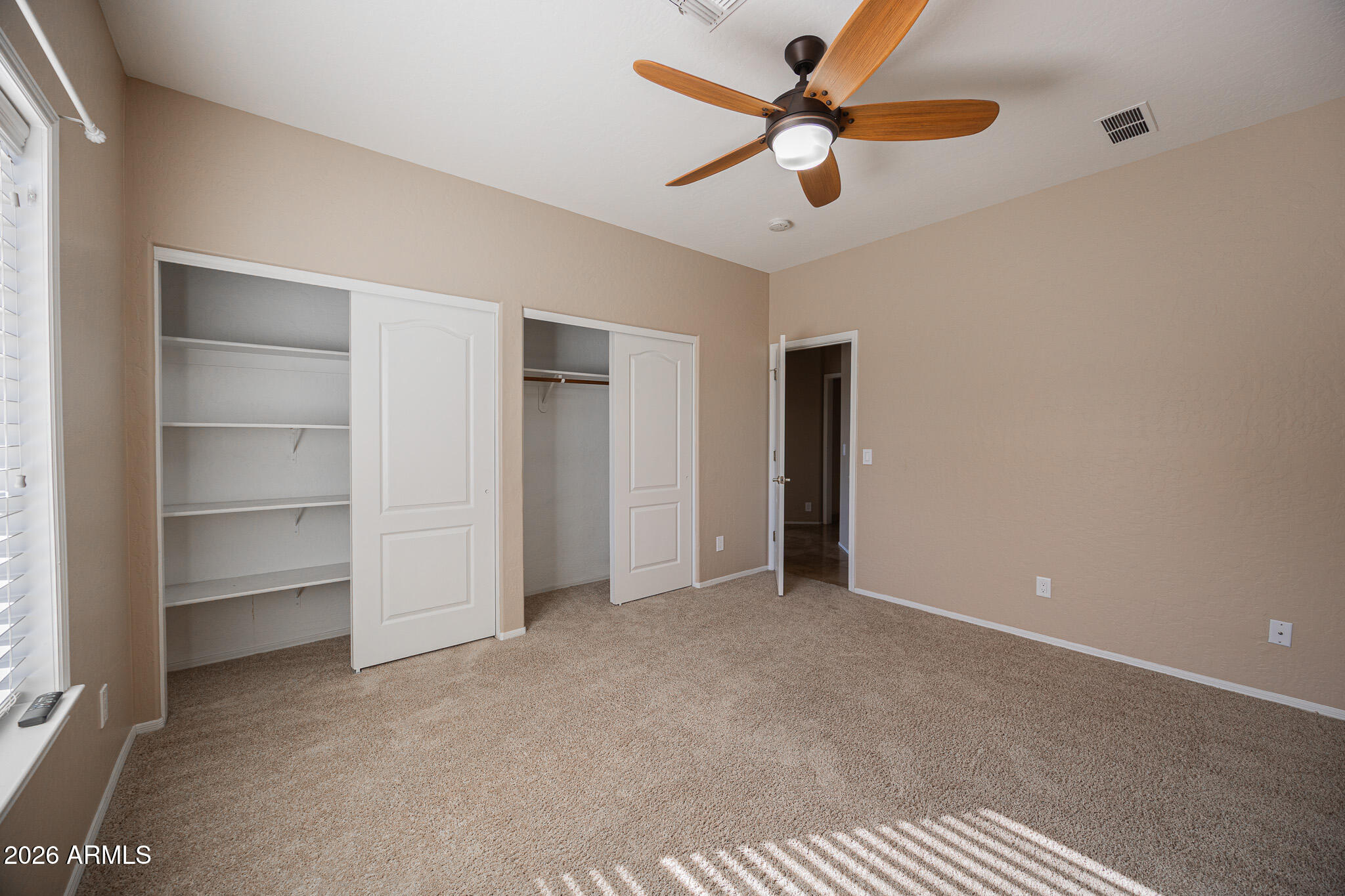 1767 West Redfield Road Gilbert, AZ 85233 - Photo 26 of 40 a view of an empty room with a ceiling fan