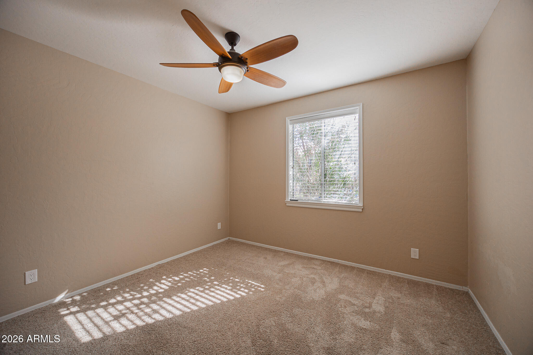 1767 West Redfield Road Gilbert, AZ 85233 - Photo 33 of 40 an empty room with a ceiling fan and window