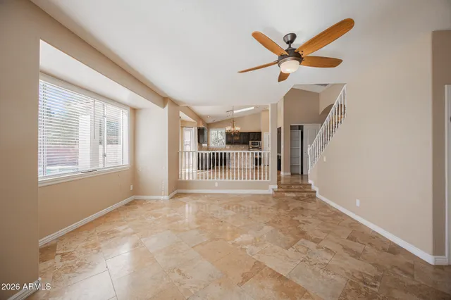 a view of a livingroom with a ceiling fan and window