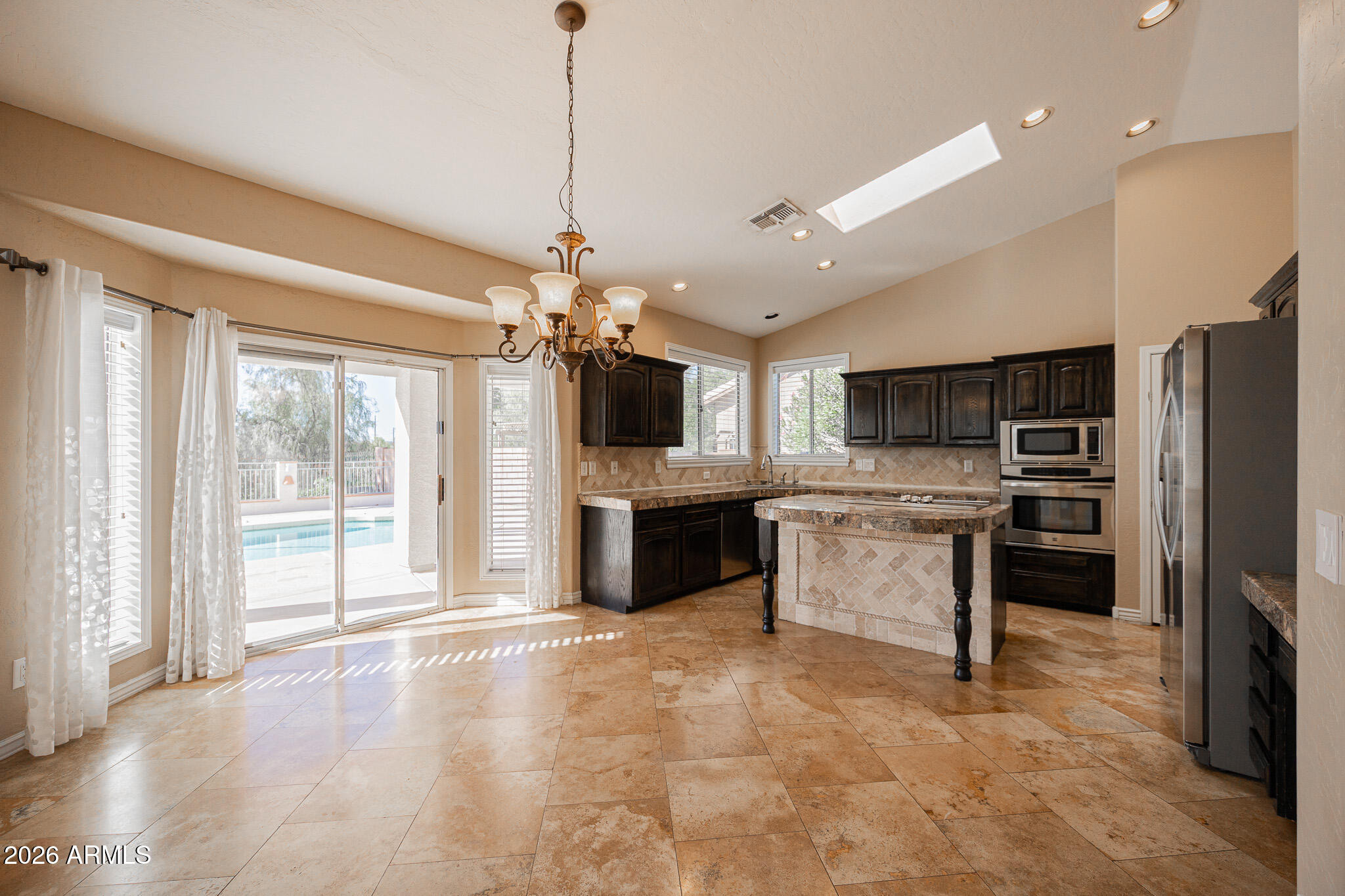 1767 West Redfield Road Gilbert, AZ 85233 - Photo 9 of 40 a large kitchen with a large counter top appliances and cabinets