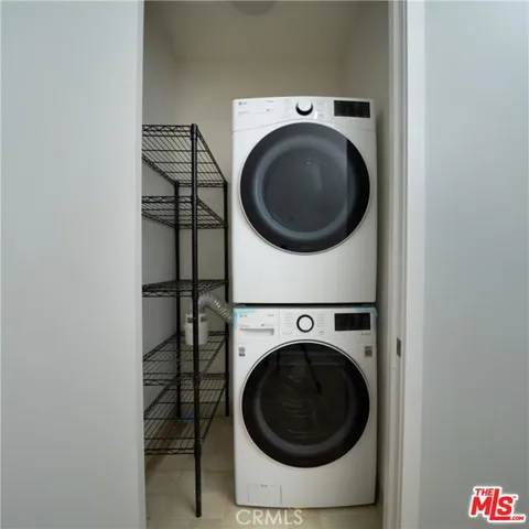 a view of a hallway with wooden floor and closet