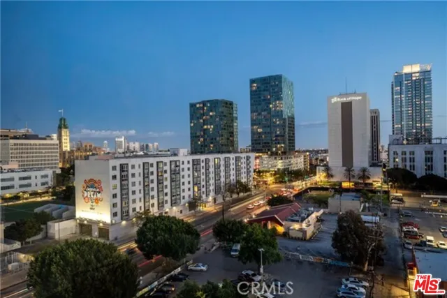 a view of a kitchen with a sink and a refrigerator