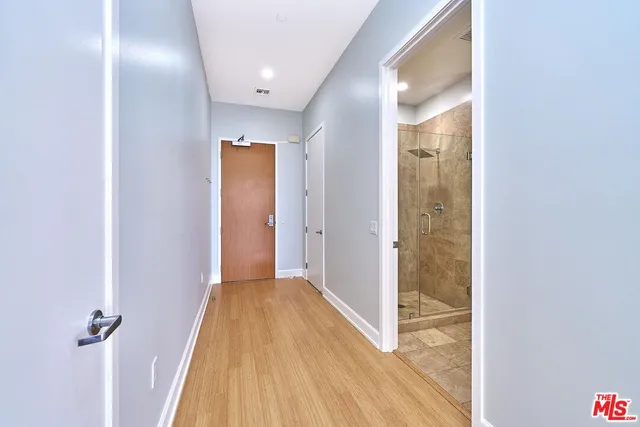 a view of an empty room with wooden floor