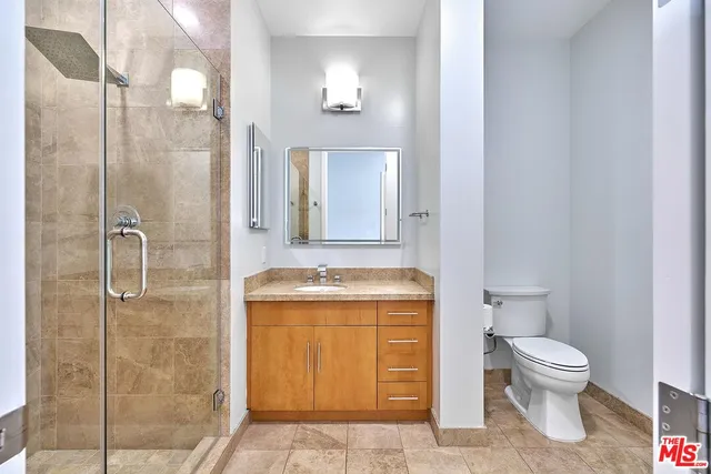 a view of a livingroom with wooden floor and a ceiling fan