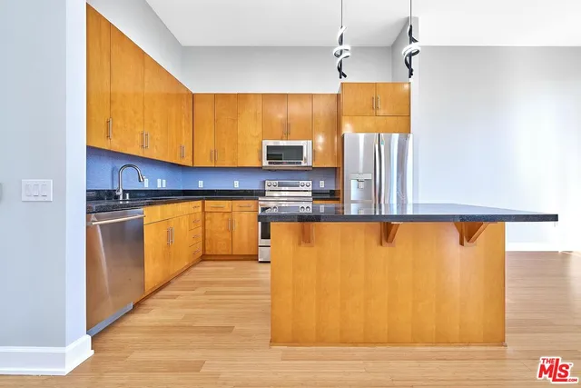 a view of a room with a hallway and wooden shelves