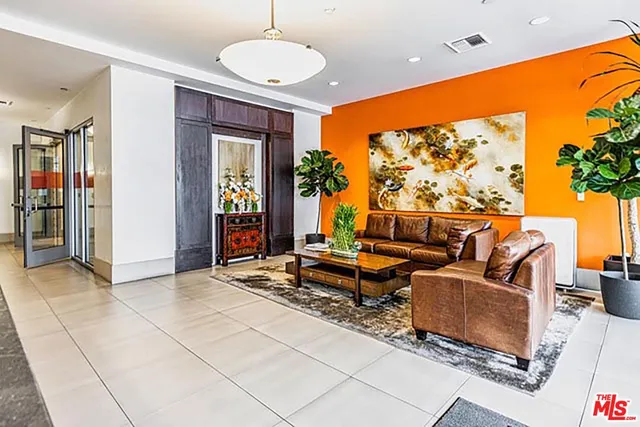 a living room with furniture a window and a flat screen tv