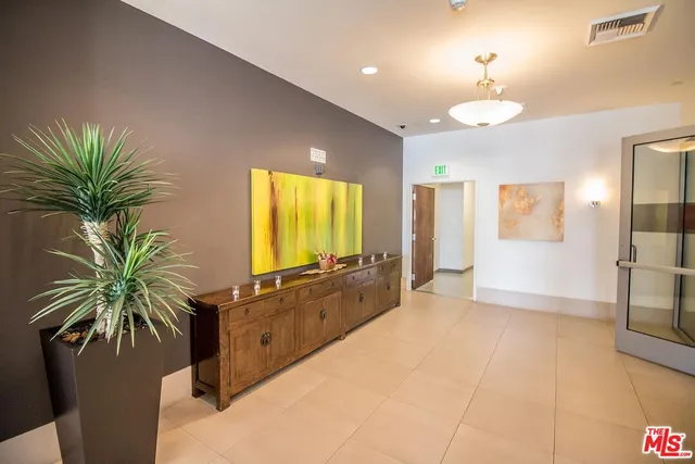 a living room with furniture kitchen view and a large window