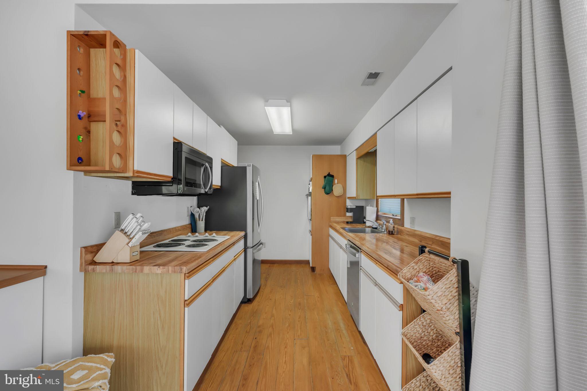 33 Lagrange Avenue Kilmarnock, VA 22482 - Photo 69 of 84 a kitchen with stainless steel appliances granite countertop a stove a sink and a refrigerator