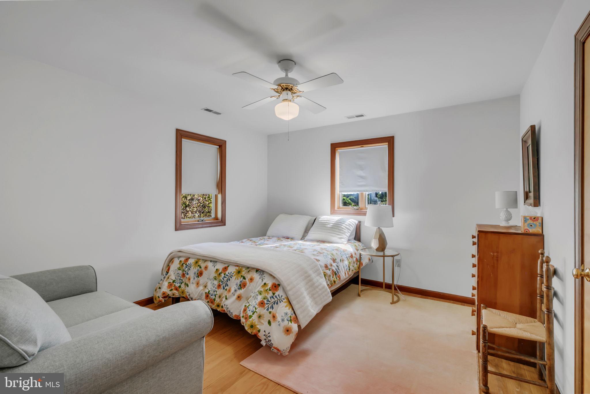 33 Lagrange Avenue Kilmarnock, VA 22482 - Photo 77 of 84 a bedroom with a bed and a chandelier