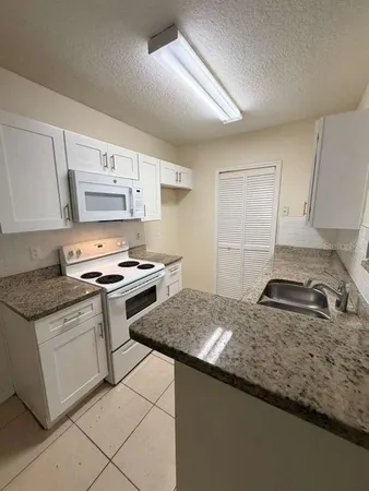 a kitchen with stainless steel appliances granite countertop a stove and a sink