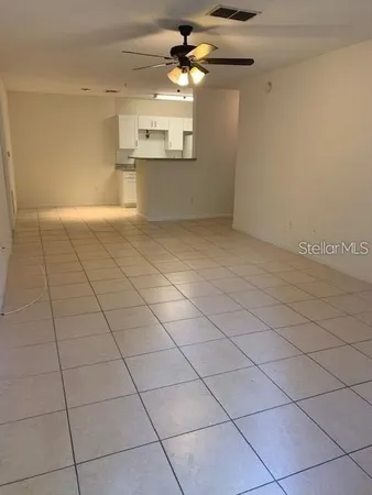 a view of a kitchen with furniture and a ceiling fan