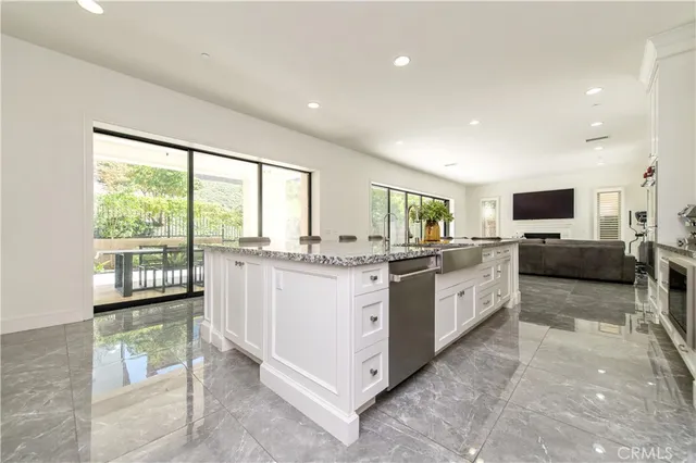 a kitchen with stainless steel appliances kitchen island granite countertop a sink and cabinets