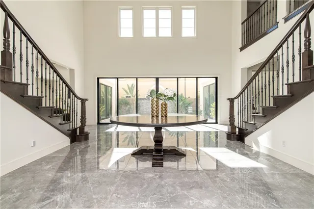a view of a hallway with wooden floor and windows