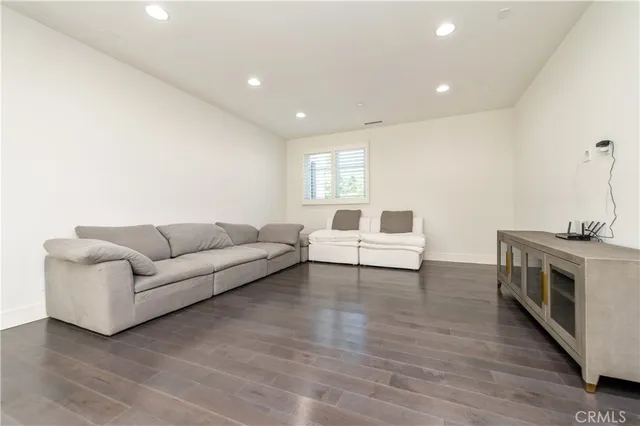 a bedroom with a bed a table and a dresser