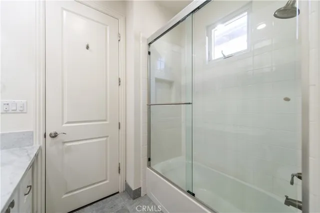 a spacious bedroom with a bed and wooden floor