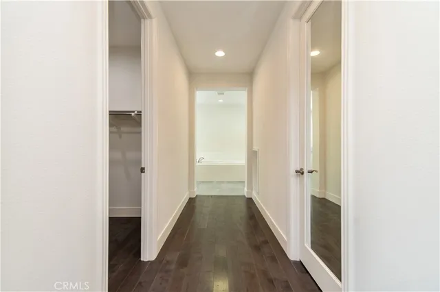 a spacious bathroom with a bathtub sink and mirror