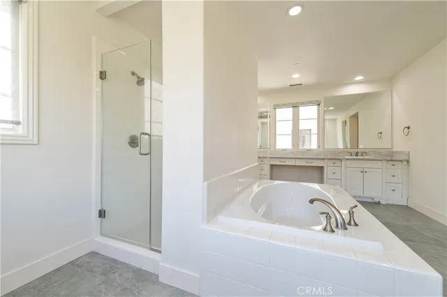 a kitchen with white cabinets and a window