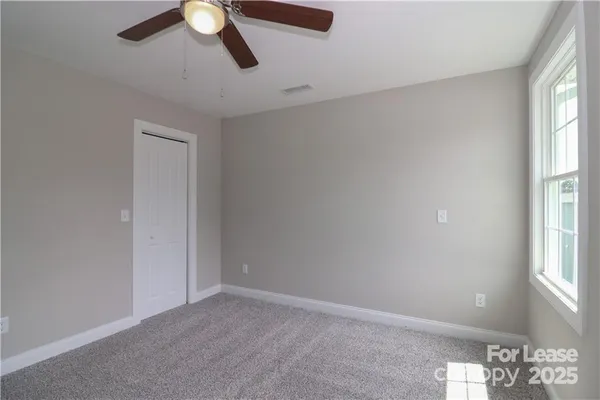 an empty room with windows and entrance