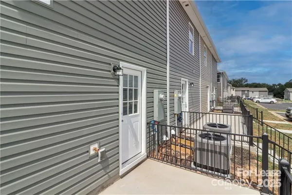 a view of a house with a door and a yard
