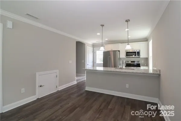 a view of kitchen with wooden floor