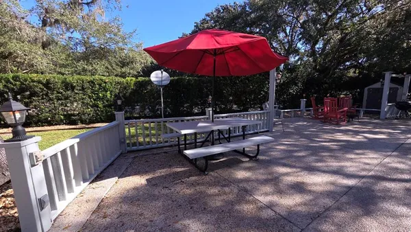 a view of a swimming pool with sitting area and furniture