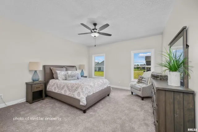 a bedroom with a bed and ceiling fan