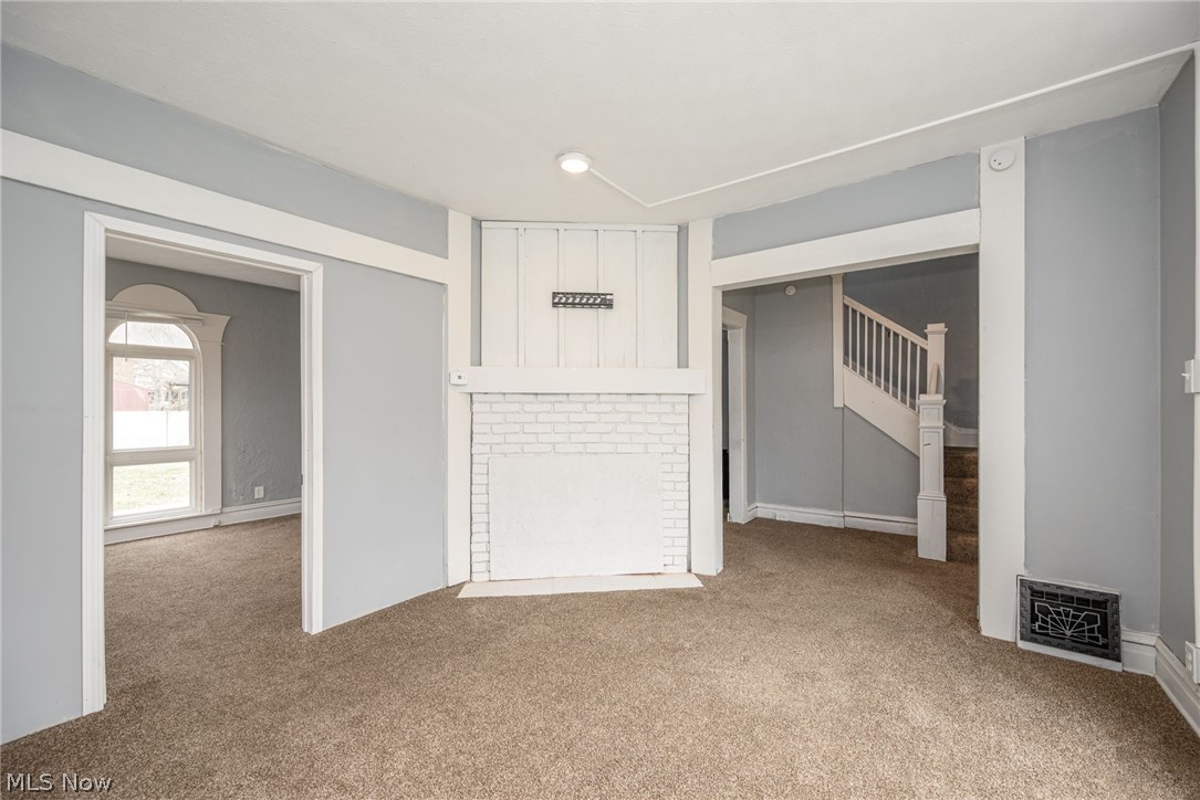 1603 Hampton Road Akron, OH 44305 - Photo 10 of 50 Unfurnished living room with light carpet and a brick fireplace