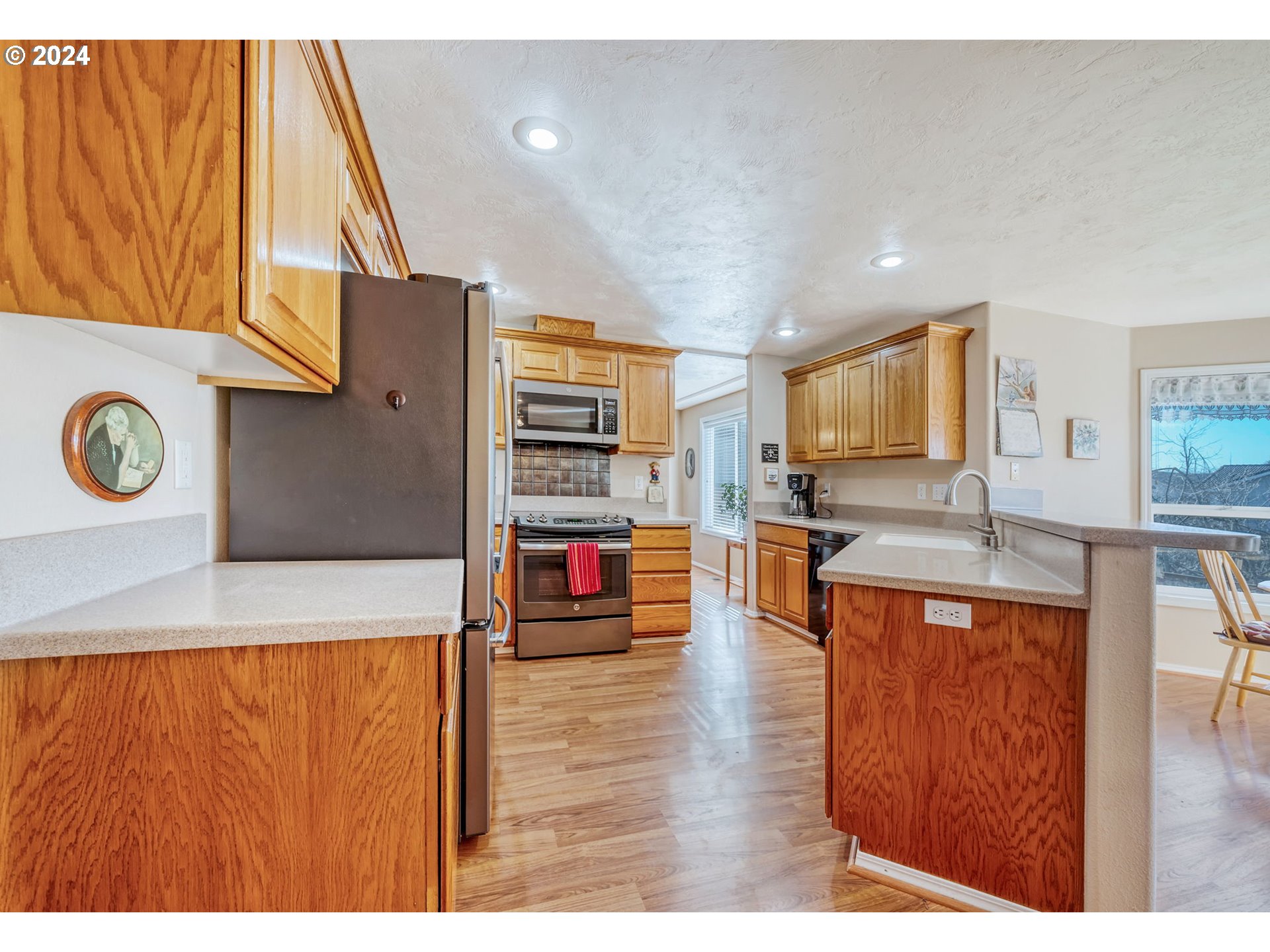 2278 33rd Street Springfield, OR 97477 - Photo 11 of 41 a living room with stainless steel appliances kitchen island granite countertop furniture and a wooden floor