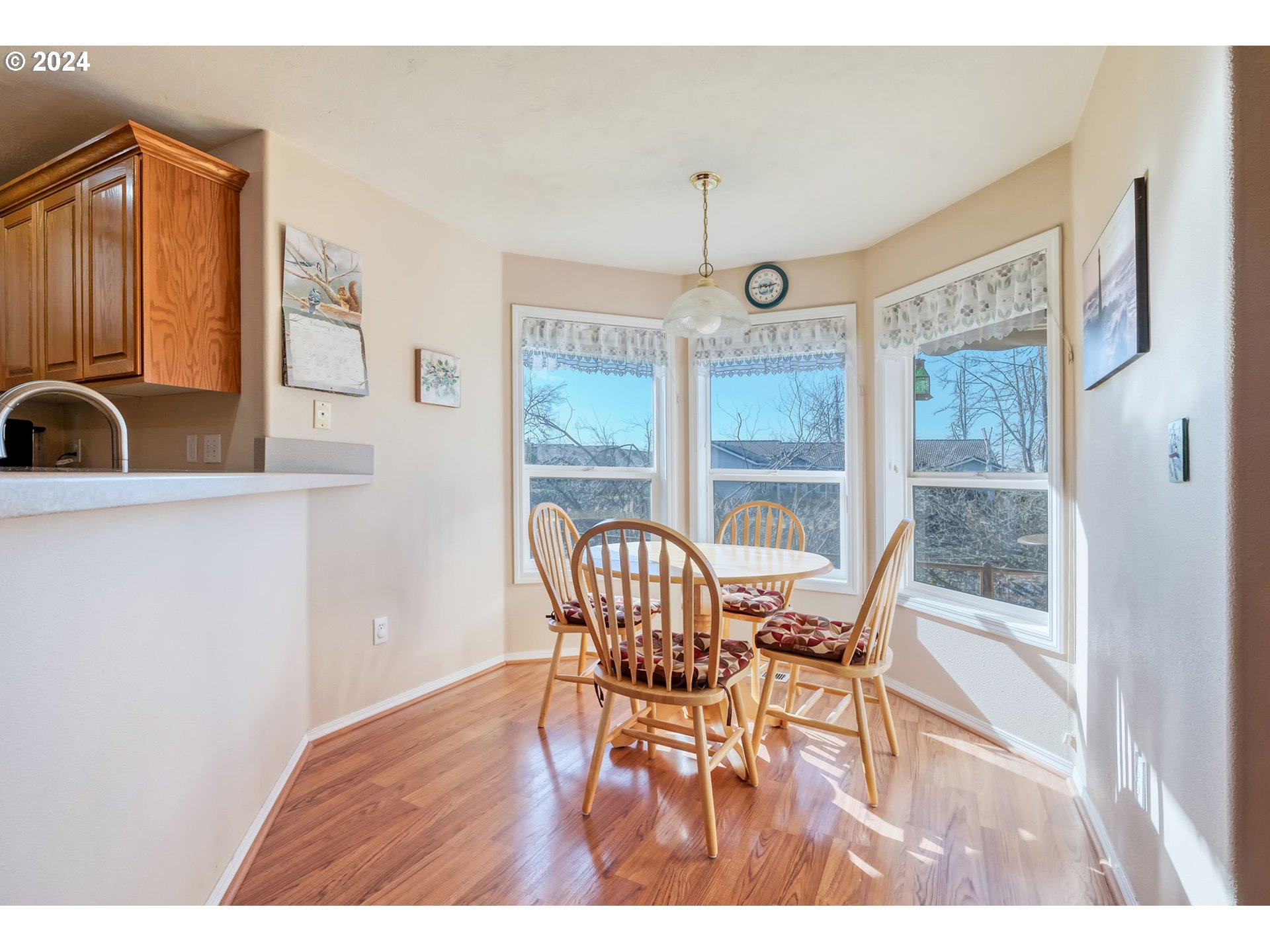 2278 33rd Street Springfield, OR 97477 - Photo 13 of 41 a view of a dining room with furniture a chandelier and wooden floor