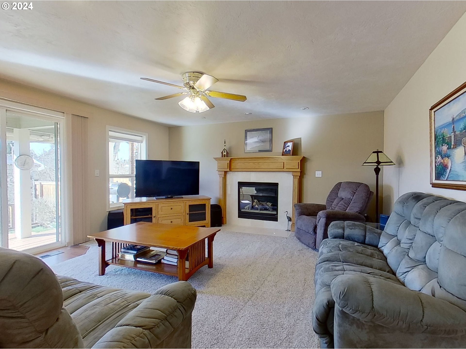 2278 33rd Street Springfield, OR 97477 - Photo 16 of 41 a living room with furniture a window and a fireplace
