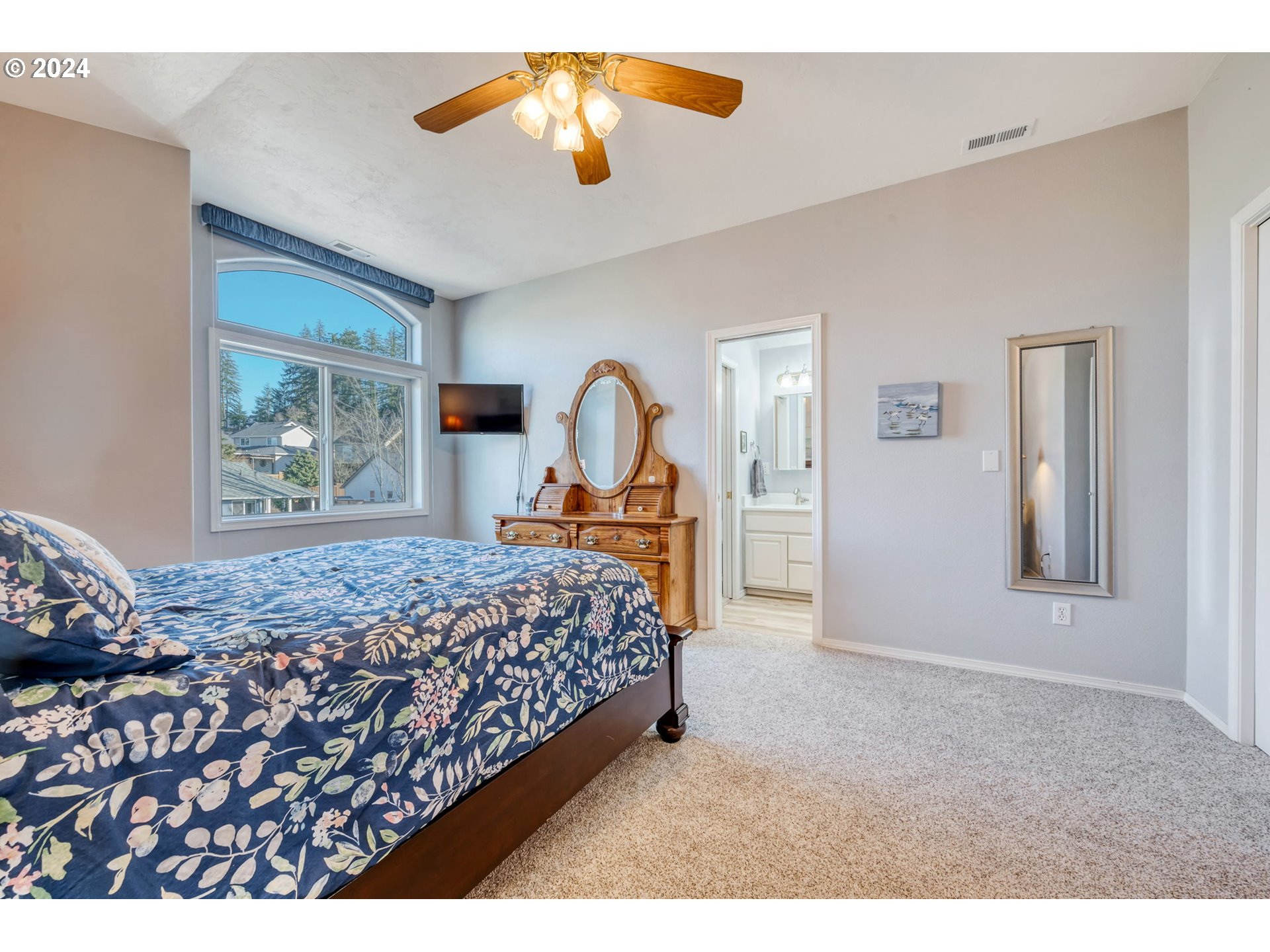 2278 33rd Street Springfield, OR 97477 - Photo 22 of 41 a bedroom with a bed and a chandelier