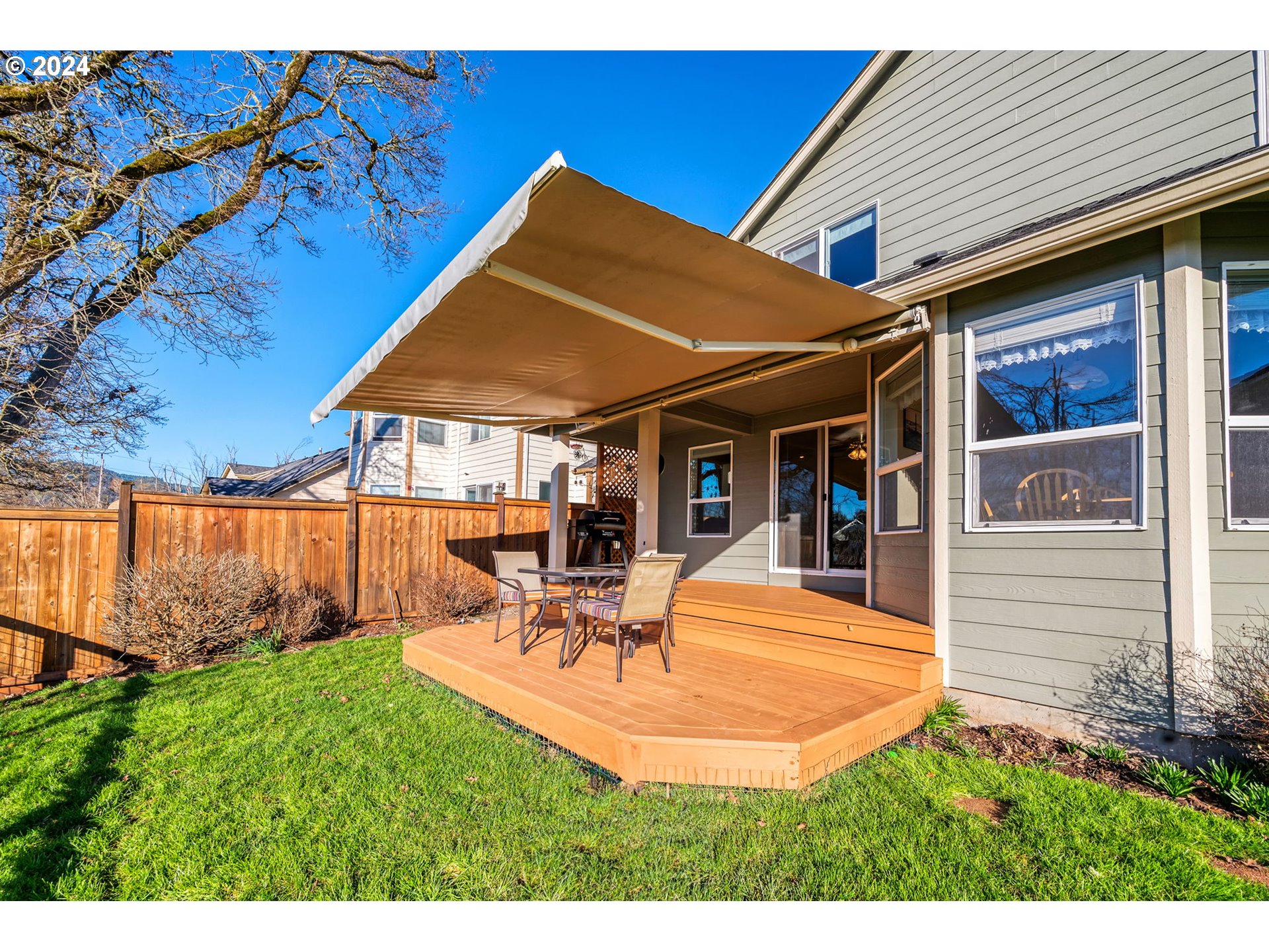 2278 33rd Street Springfield, OR 97477 - Photo 40 of 41 a view of a patio with table and chairs under an umbrella