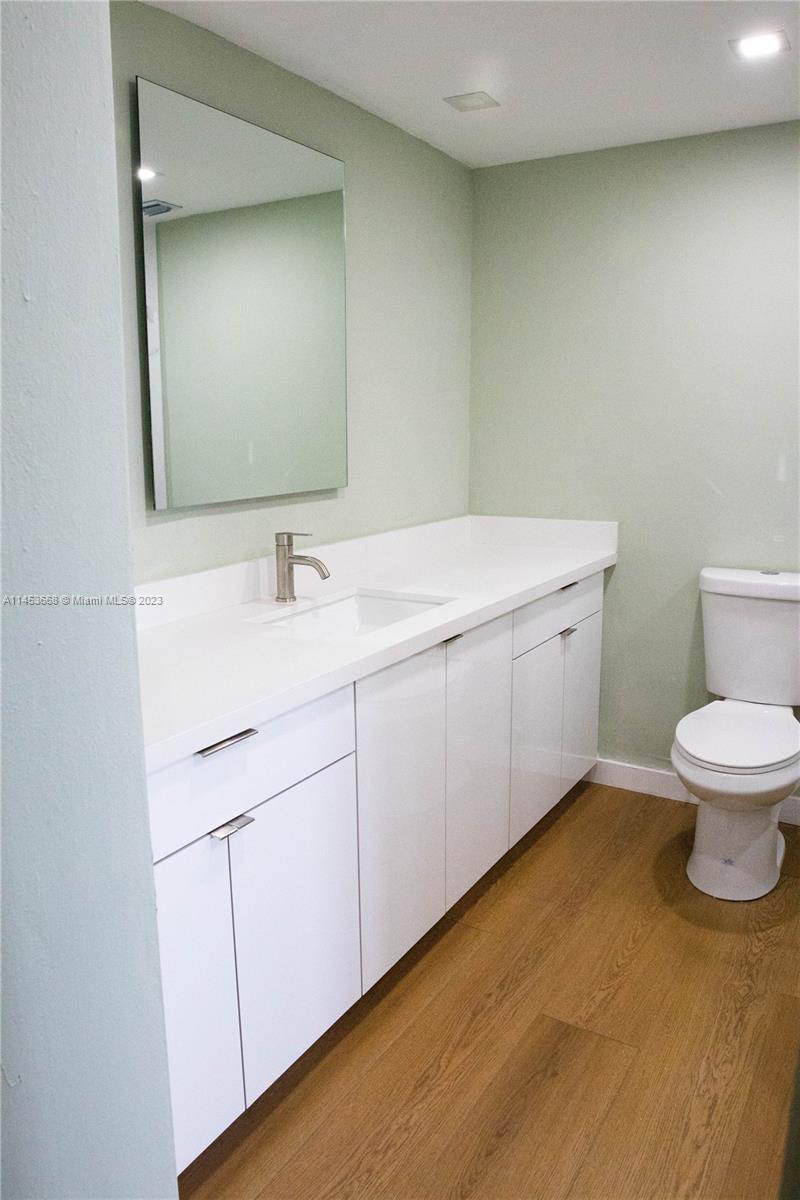 North Beach Miami Beach, FL 33141 - Photo 13 of 30 a bathroom with a toilet sink and mirror