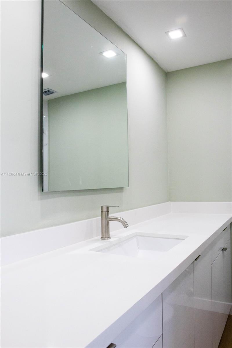 North Beach Miami Beach, FL 33141 - Photo 16 of 30 a bathroom with a sink and a mirror
