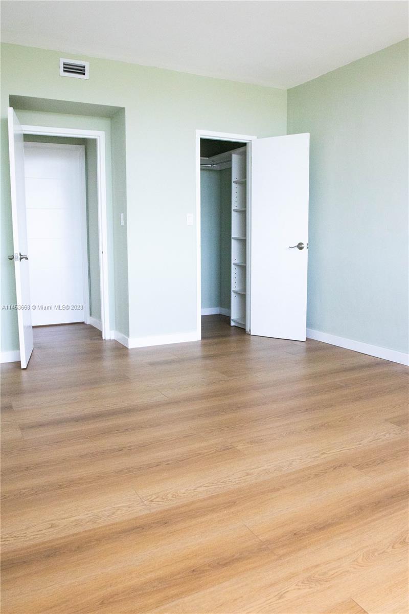 North Beach Miami Beach, FL 33141 - Photo 7 of 30 a view of an empty room with wooden floor and a window